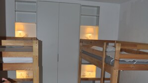 A room with bunk beds, a wardrobe, and bedside lamps. - House / Villa - Rayol-Canadel-sur-Mer (Rayol-Canadel-Sur-Mer)