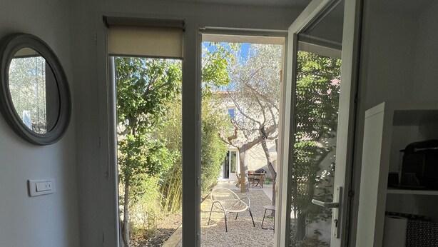 A room with a sliding glass door leading to an outdoor patio area.