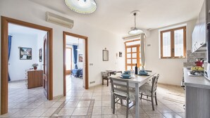 A spacious kitchen with a dining area, a large window, and a view of the outside.