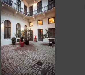 Stroll through this serene courtyard surrounded by lush greenery and a striking sculpture.