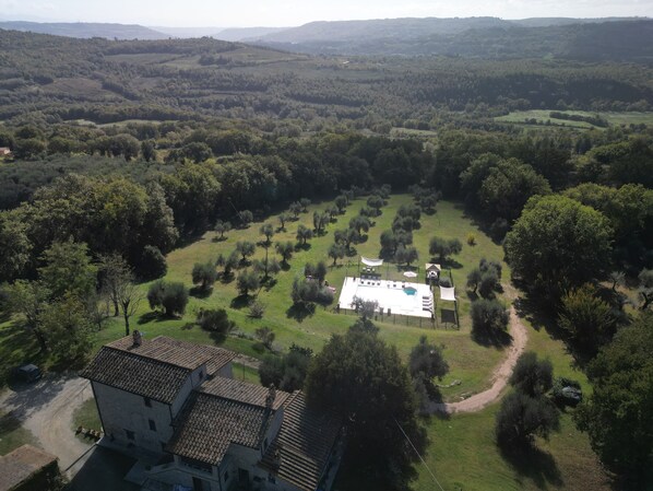 An aerial view of a property with a central building surrounded by trees and open fields. - Casale in Teverina - Entire house in countryside (Penna In Teverina)