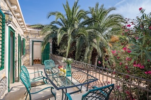 Relax on the outdoor patio surrounded by lush greenery and enjoy the tranquil atmosphere.