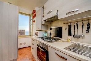 Enjoy cooking in this well-equipped kitchen with a gas stove, oven, and coffee maker.