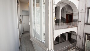 A multi-level building with balconies, staircases, and a central courtyard. - Largodonnaregina home vacation home 2 bedroom apartment historic center (Napoli)