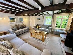 A cozy living room with two sofas, a coffee table, and a bench.