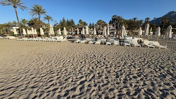 On the beach, sun-loungers, beach towels
