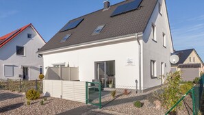 A modern two-story house with a white exterior, a grey roof, and solar panels on the roof. - Holiday home on the Baltic Sea - up to 6 persons (4 stars) (Zierow)