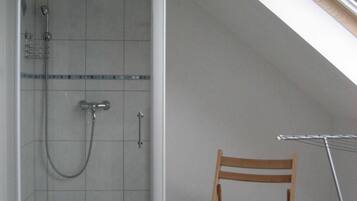 Shower, hair dryer, soap, toilet paper