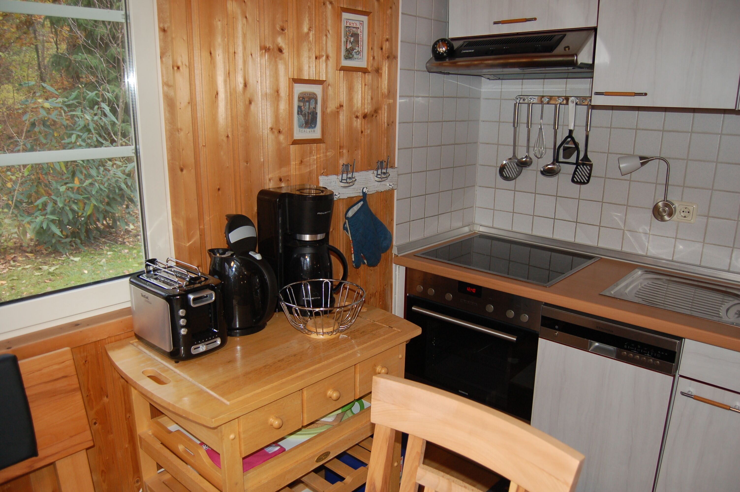 Una cucina con mobili in legno, un tostapane, una macchina da caffè e un lavello.