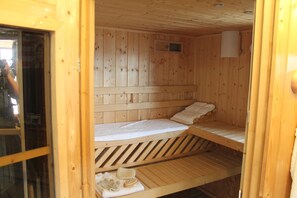 A wooden sauna room with two benches and a small window. - 120m² apartment with level in Kirchberg, in the heart of the Bavarian Forest. (Kirchberg im Wald)