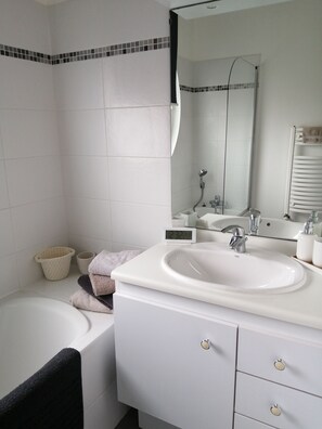 Bathtub, hair dryer, towels, soap