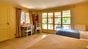 Une chambre à coucher avec un lit, un bureau et une chaise, une bibliothèque et une fenêtre avec des rideaux.