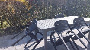 A patio with a table and four chairs.