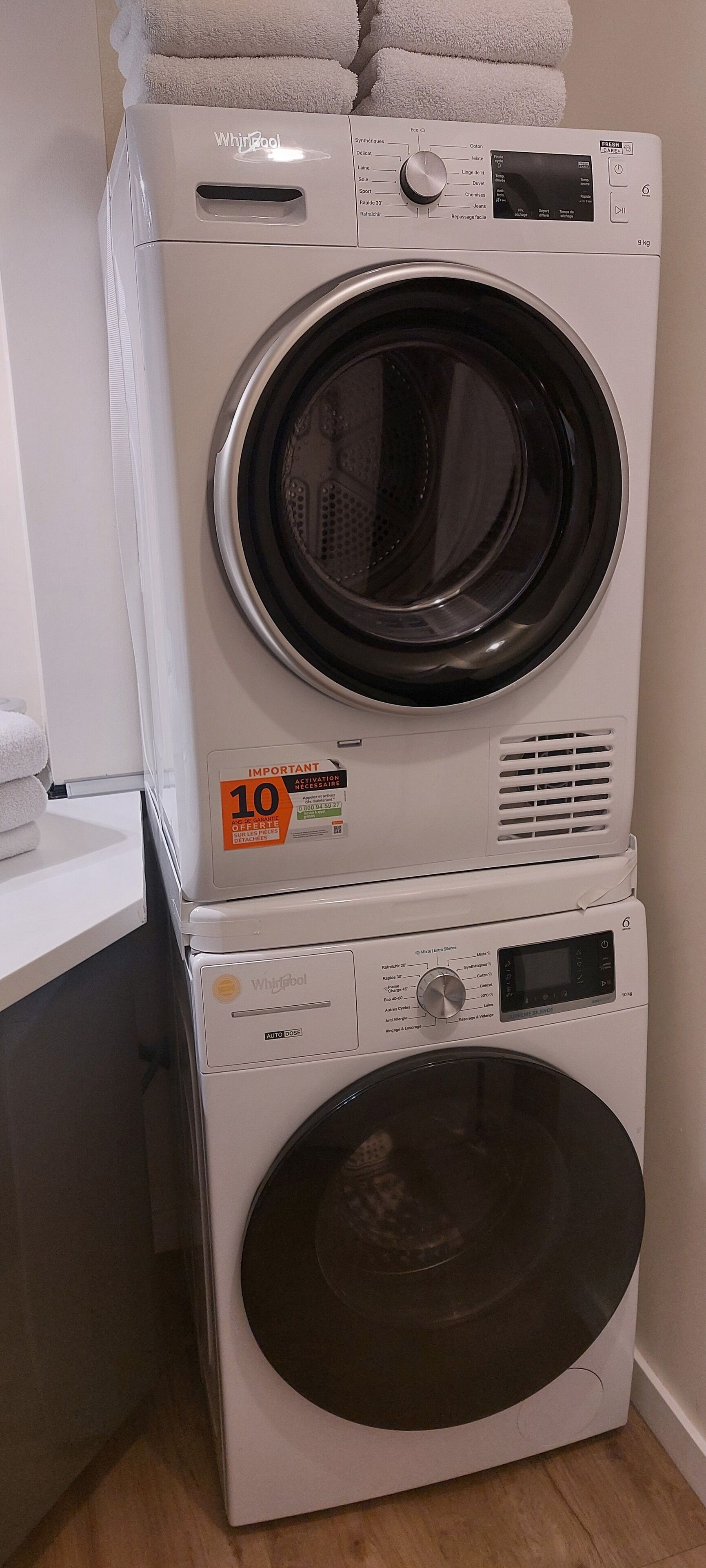 A stacked washer and dryer unit with a control panel, a digital display, and a label indicating a 10 kg capacity.