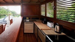 A compact kitchen with wooden countertops, a sink, a toaster, and a kettle. - Villa Kaz Coco, sea views (Deshaies)