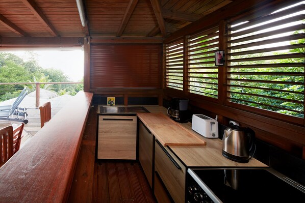 A compact kitchen with wooden countertops, a sink, a toaster, and a kettle. - Villa Kaz Coco, sea views (Deshaies)