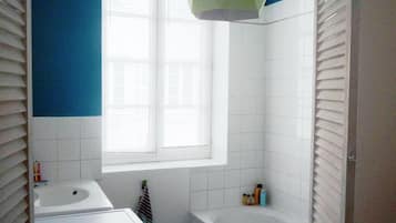 Bathtub, hair dryer, towels, soap