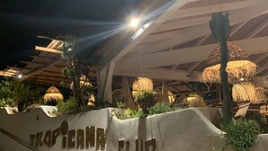 A nighttime view of a resort entrance with a sign reading "TRAPICAN CLUB". - MAZET with superb sea view and beautiful terrace - 500 m beach (Rayol-Canadel-Sur-Mer)