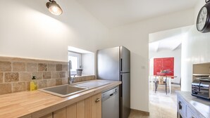 A modern kitchen with a stainless steel refrigerator, a double sink, and wooden cabinetry. - Farmhouse in the middle of the Provence  (Moustiers-Sainte-Marie)