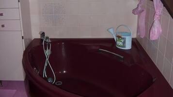 Bathtub, hair dryer, towels, toilet paper