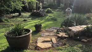 A garden pathway with potted plants and stone steps. - Charm & Tranquility in the heart of Périgord Noir with private heated pool (Le Bugue)