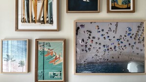 A wall with six framed artworks depicting various beach and surf scenes. - Studio 2 blocks to Beach w/ Parking - Close to LAX (Manhattan Beach)