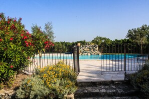 Surrounded by lush greenery and vibrant flowers, this pool offers a secure and space.