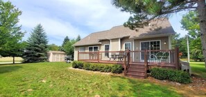 A two-story house with a deck, a garage, and a well-maintained lawn. - The Salisbury House in Empire Close to Beach (Empire)