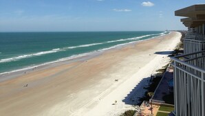 A beach view from a balcony with a clear sky, a sandy beach, and the ocean. - Corner Penthouse - 1101 - Direct Ocean Front with views of Ocean and Intercostal (Daytona Beach)