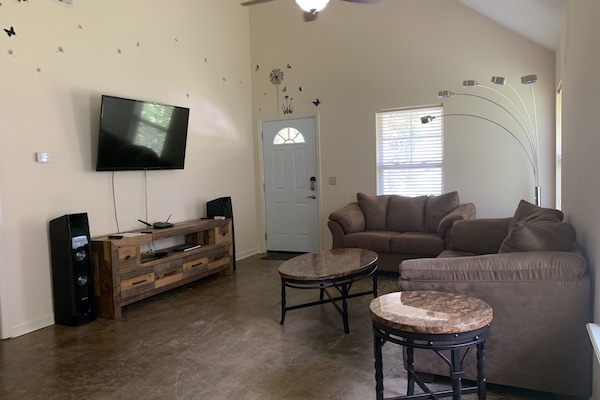 Living room with 55 inch TV connected to Apple TV and two Samsung stereo speaker