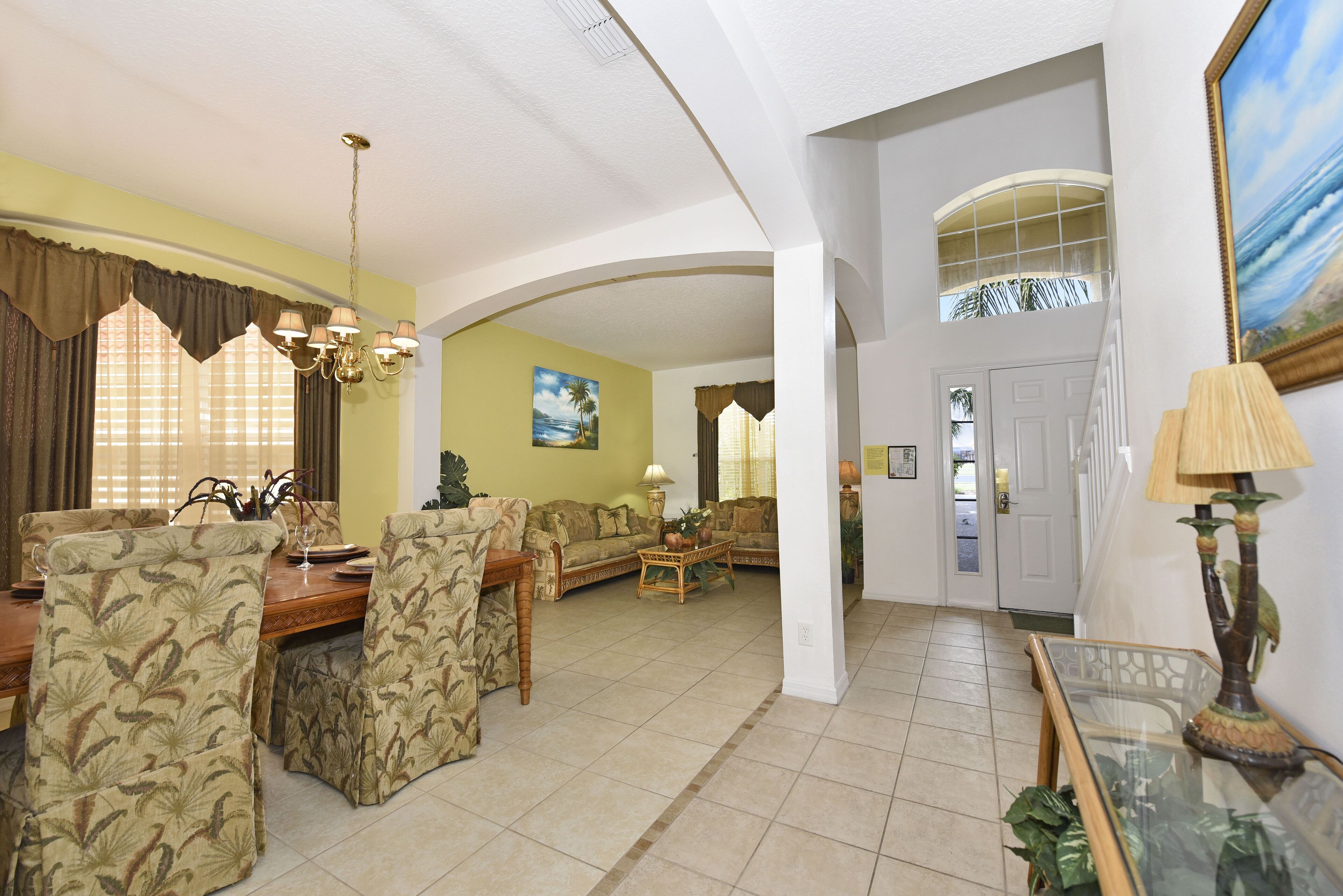 A spacious living area with a dining set, a sofa, and a coffee table.