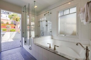 Bathtub, hair dryer, towels, shampoo