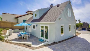 A single-story house with a sloped roof, a patio with outdoor furniture, and a fenced backyard. - Village Life, walk to the village of La Jolla (La Jolla)