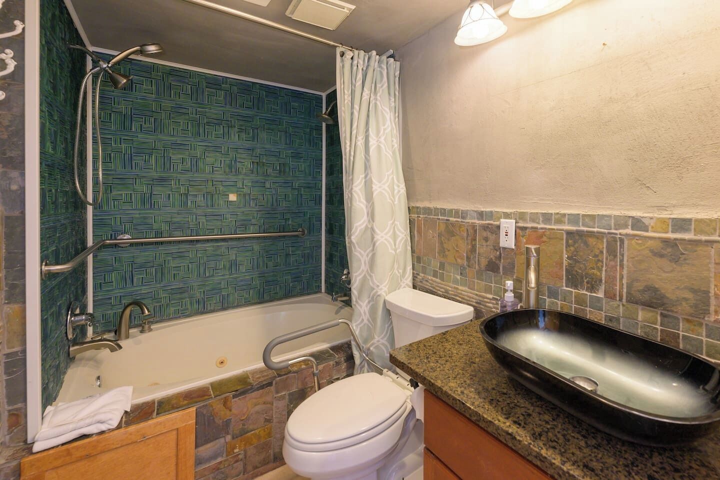 A bathroom with a bathtub, toilet, and sink.