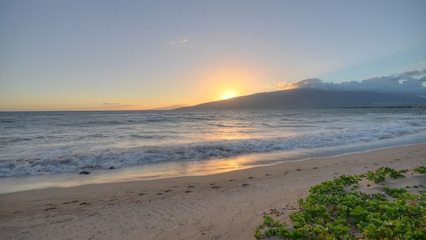 A beach with waves, a sunset, and a distant mountain. - Maui Special!! 2BDRM/2BA Ocean View and Convenient Location (Kihei)