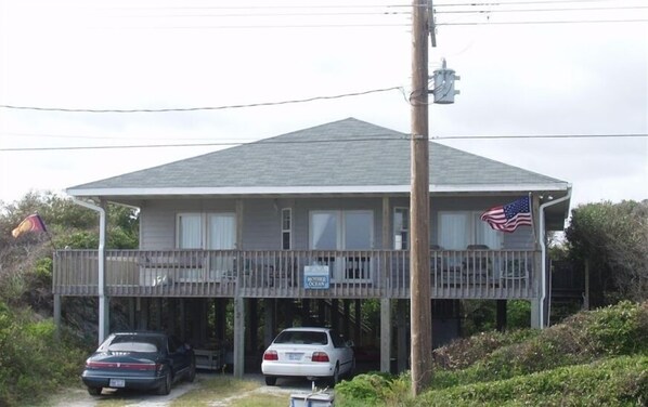 Mother Ocean building features a two-story design with a flat roof and a second-floor balcony.