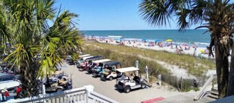 One minute drive to beach with golfcart! Updated, beach decor & clean! 