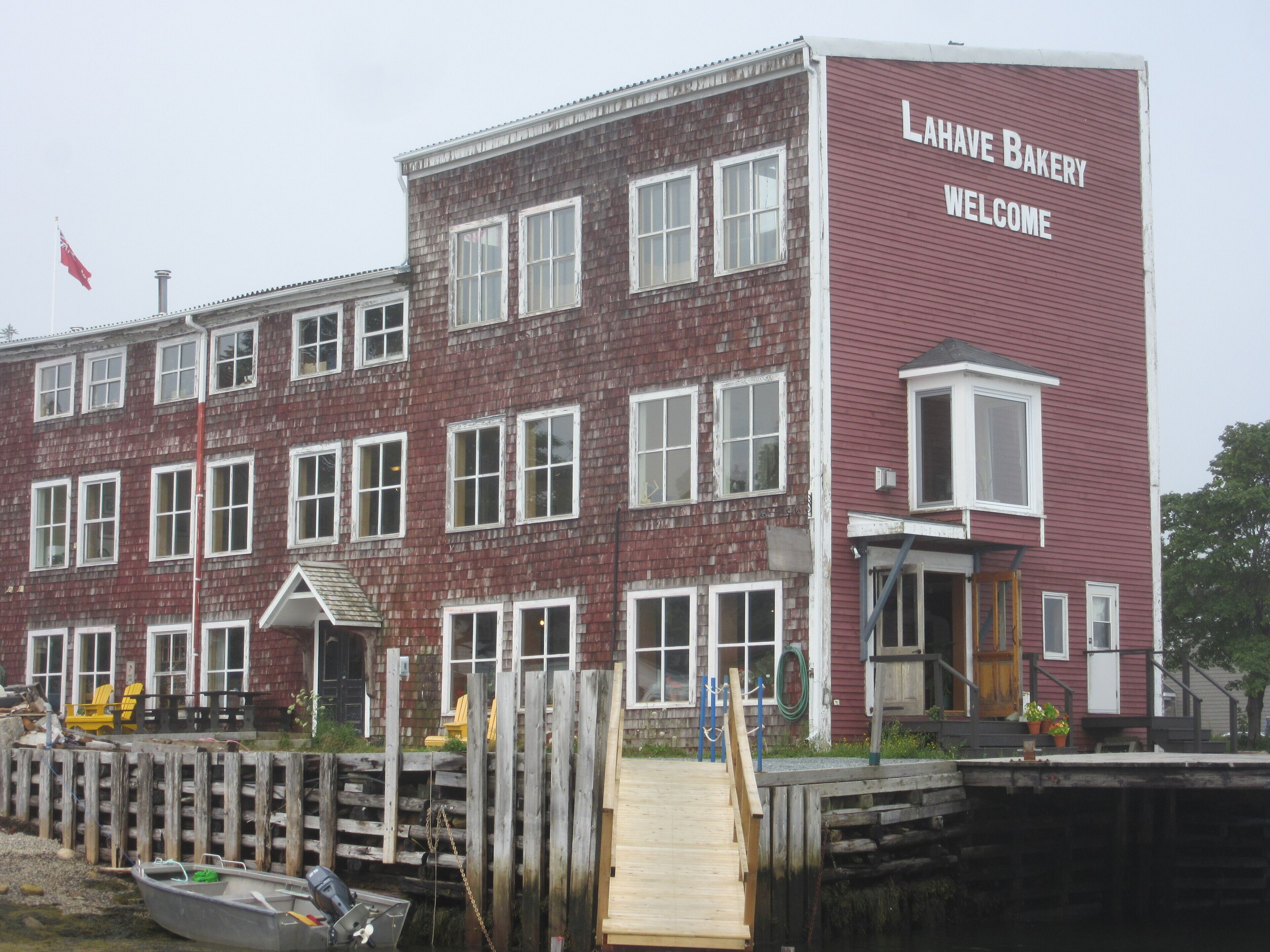A red building with a sign reading "Lahve Bakery Welcome".