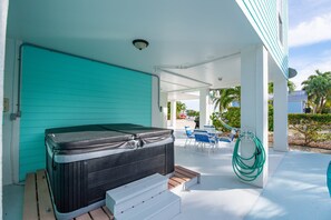 A hot tub on a covered patio with a view of a pool and palm trees. - Fandango - private pool <br>This is a pet friendly home. A pet fee and approval of your pet is required. (Cudjoe Key)