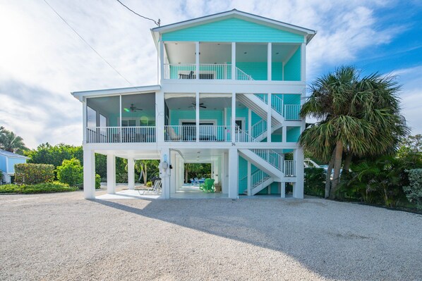 A two-story beachfront house with a balcony, a covered porch, and a staircase leading to the upper level. - Fandango - private pool <br>This is a pet friendly home. A pet fee and approval of your pet is required. (Cudjoe Key)