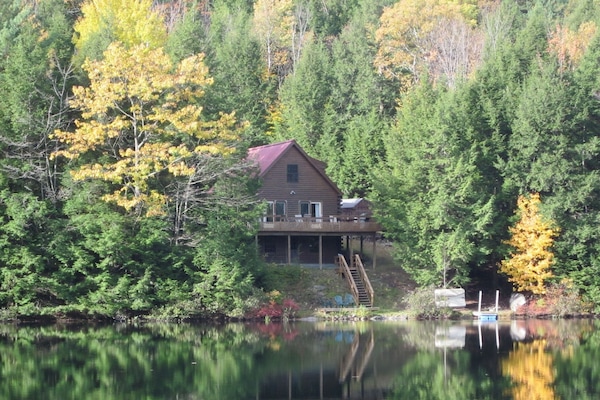View of cabin from lake in October