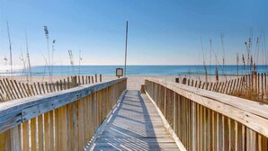 A wooden boardwalk leading to a beach with a clear sky. - Gorgeous Beach Front Corner Unit with Luxury Designer Updates /Mediterranean @PK (Pensacola)