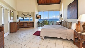 A spacious bedroom with a large bed, a wooden ceiling, and a view of the ocean. -  3 Bedroom, 3 Bath Oceanfront Condo With Amazing Views of Molakai and Lanai  (Lahaina)