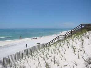 A beach with a wooden walkway leading to the shore, sandy dunes, and the ocean. - Cozy 4th Floor 2 BR/2 BA Condo in Gulf Place.  Awesome view.  Netflix included. (Santa Rosa Beach)