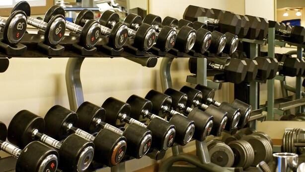 A gym with rows of dumbbells on racks. - ** Ypcfitness & Accomodations ** (Invermere)