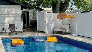A swimming pool with two yellow kickboards and a blue inflatable float.