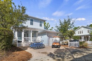 A two-story house with a porch, a bicycle rack, and a golf cart. - 6-Seater Golf Cart & 6 Bikes! Spacious Porches! Balconies w/ Views of the Pond! Latitude Adjustment (Santa Rosa Beach)