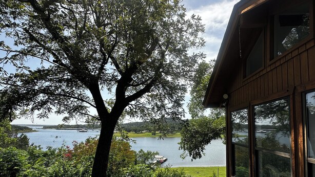 A wooden cabin with large windows overlooking a lake. - Lake Travis Waterfront Home - 4 Bed, 2 Bath, spectacular views, & private dock (Austin)