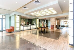 Relax in style at our lobby, featuring a reception desk, plush seating area, and architectural details.