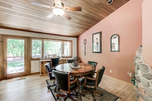 A dining area with a wooden table, chairs, and a ceiling fan. - A river runs through. Private Estate on OAK CREEK! Pickleball Court in backyard! (Sedona)